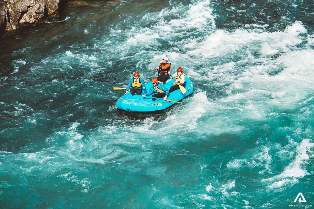 Four People Are Rafting On The River In Iceland
