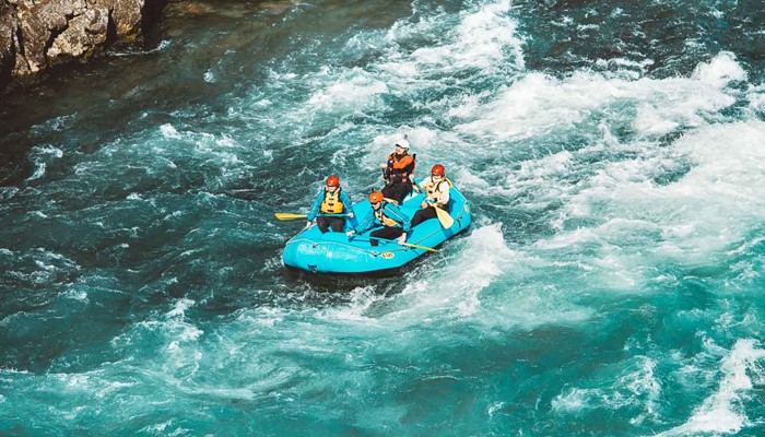 Four People Are Rafting On The River