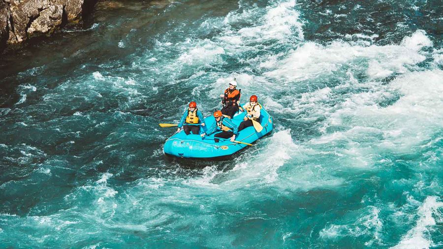 Four People Are Rafting On The River In Iceland