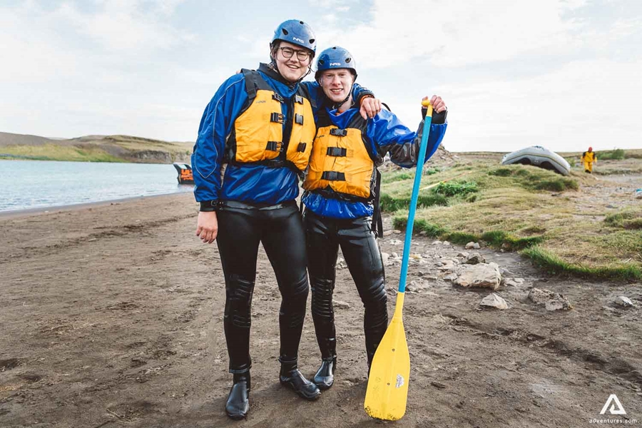 Two People Are Standing With Yellow Paddle 