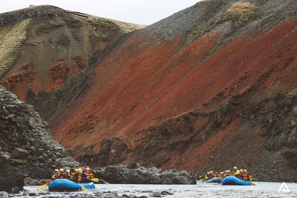 Glacial River Rafting Between Red Rocks In Iceland