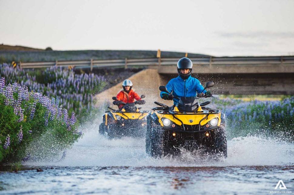 Atvs driving through a river in Iceland