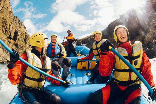 Fisheye view of happy people rafting in Iceland
