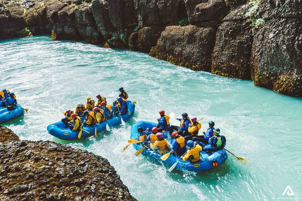 Three Boats Rafting Glacial River In Iceland