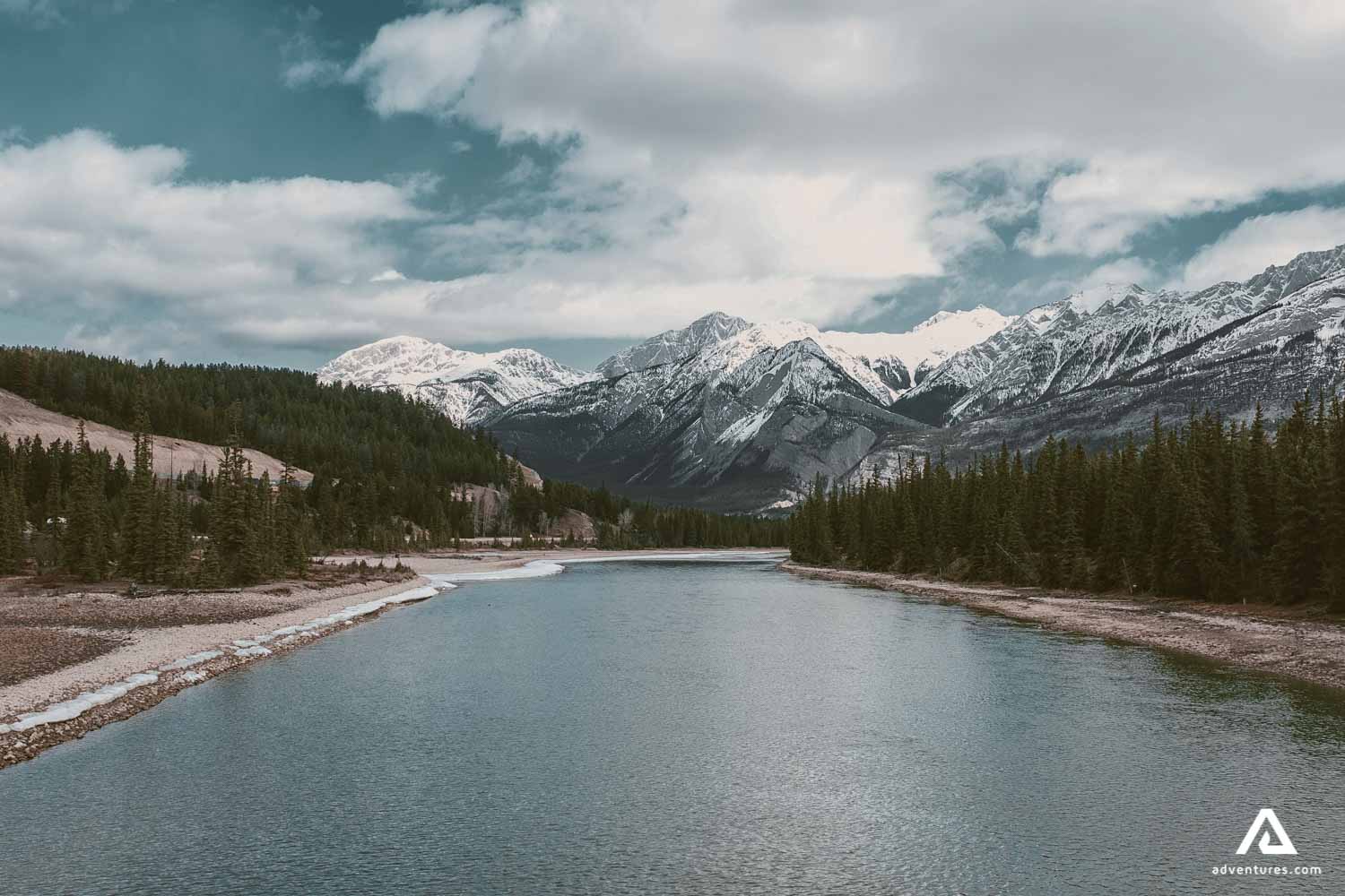 wide river near a forest in canadian rockies