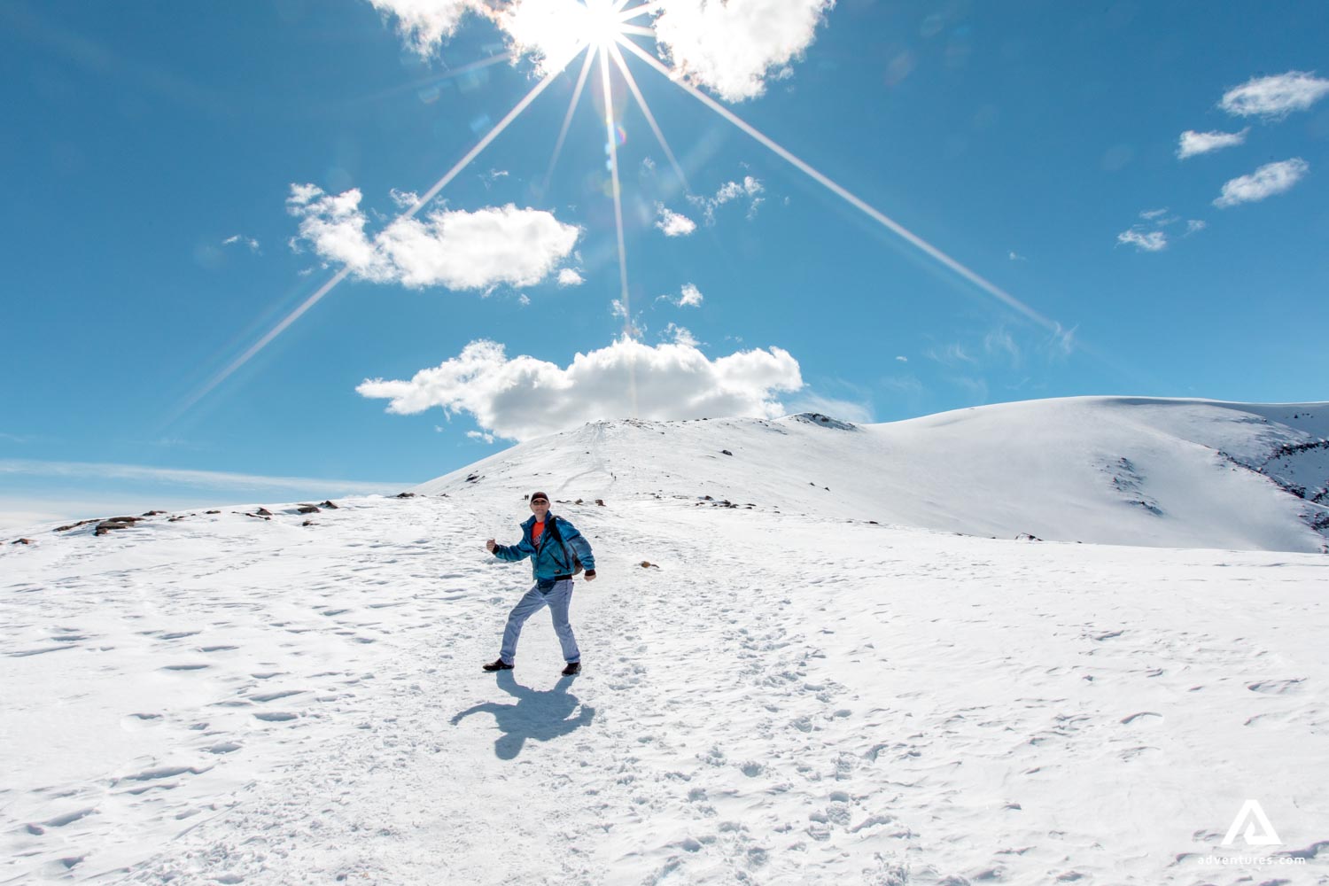 happy man hiking on snowy winter mountains in canada