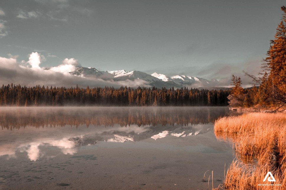 sunset above a shallow wide river in canada