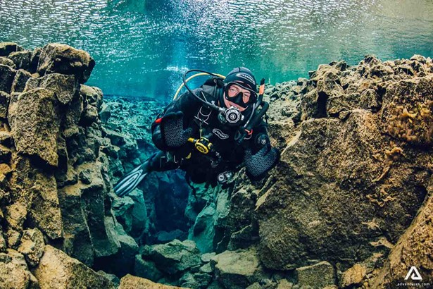 Scuba Diving Near Rocks In Silfra Iceland