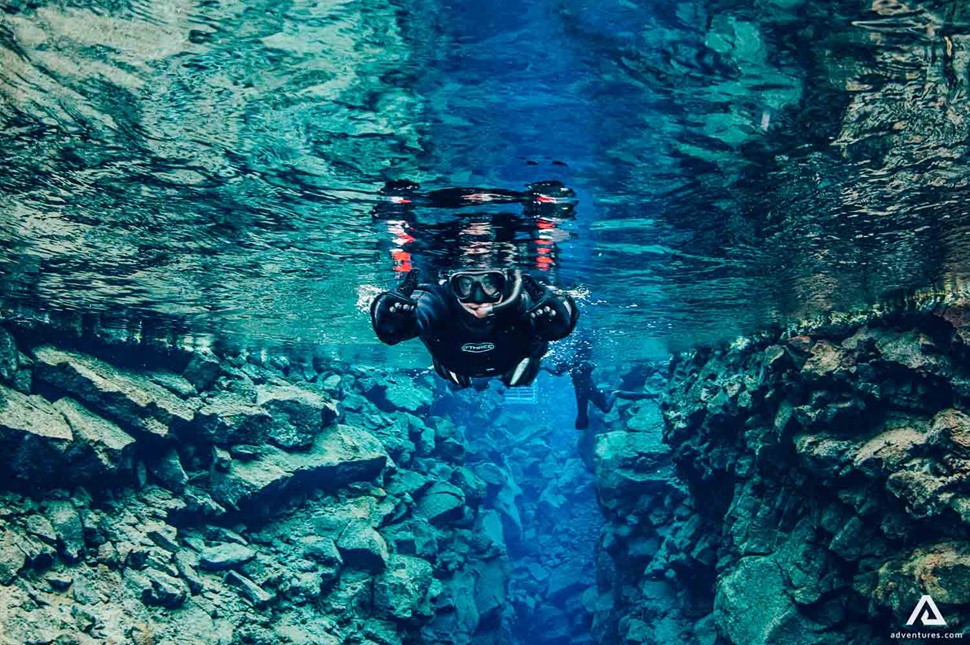 Snorkeling Silfra Fissure Near The Rocks In Iceland