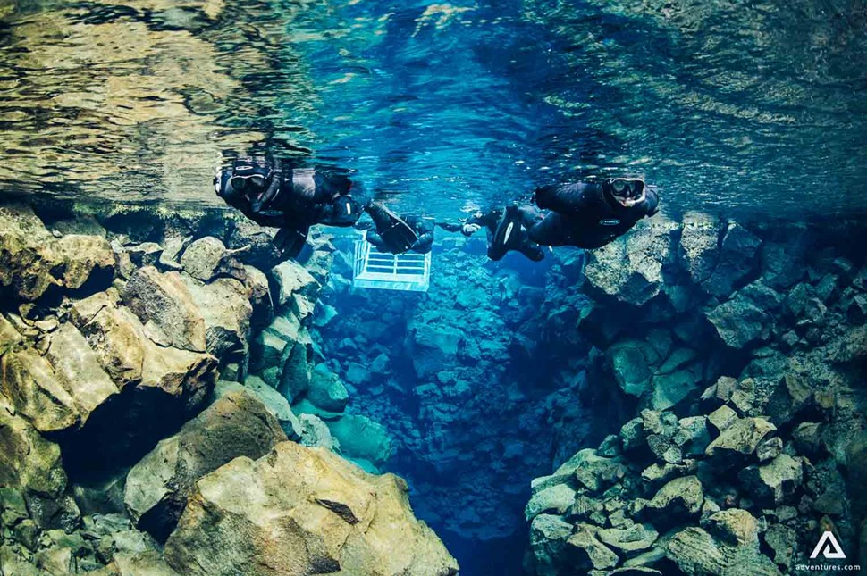 Snorkeling Silfra Near Rock In Iceland