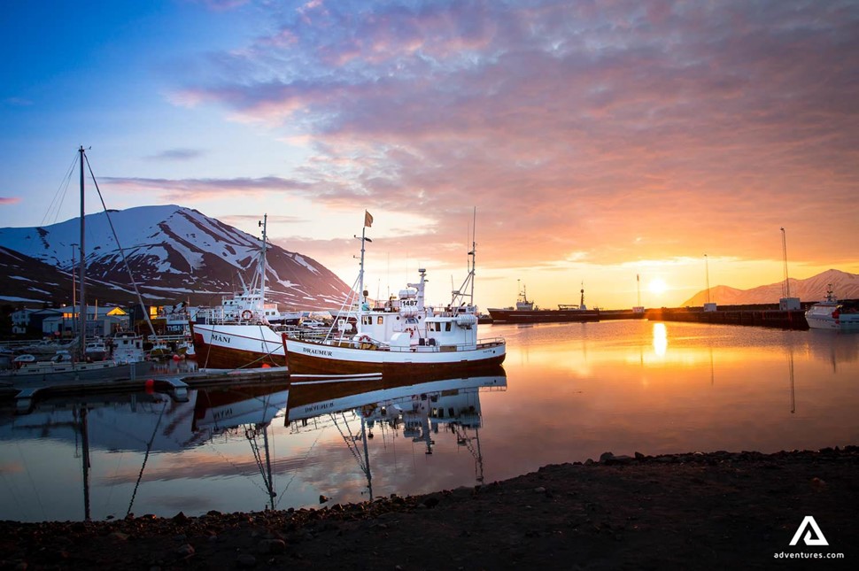 boats in dalvik harbor on a sunset