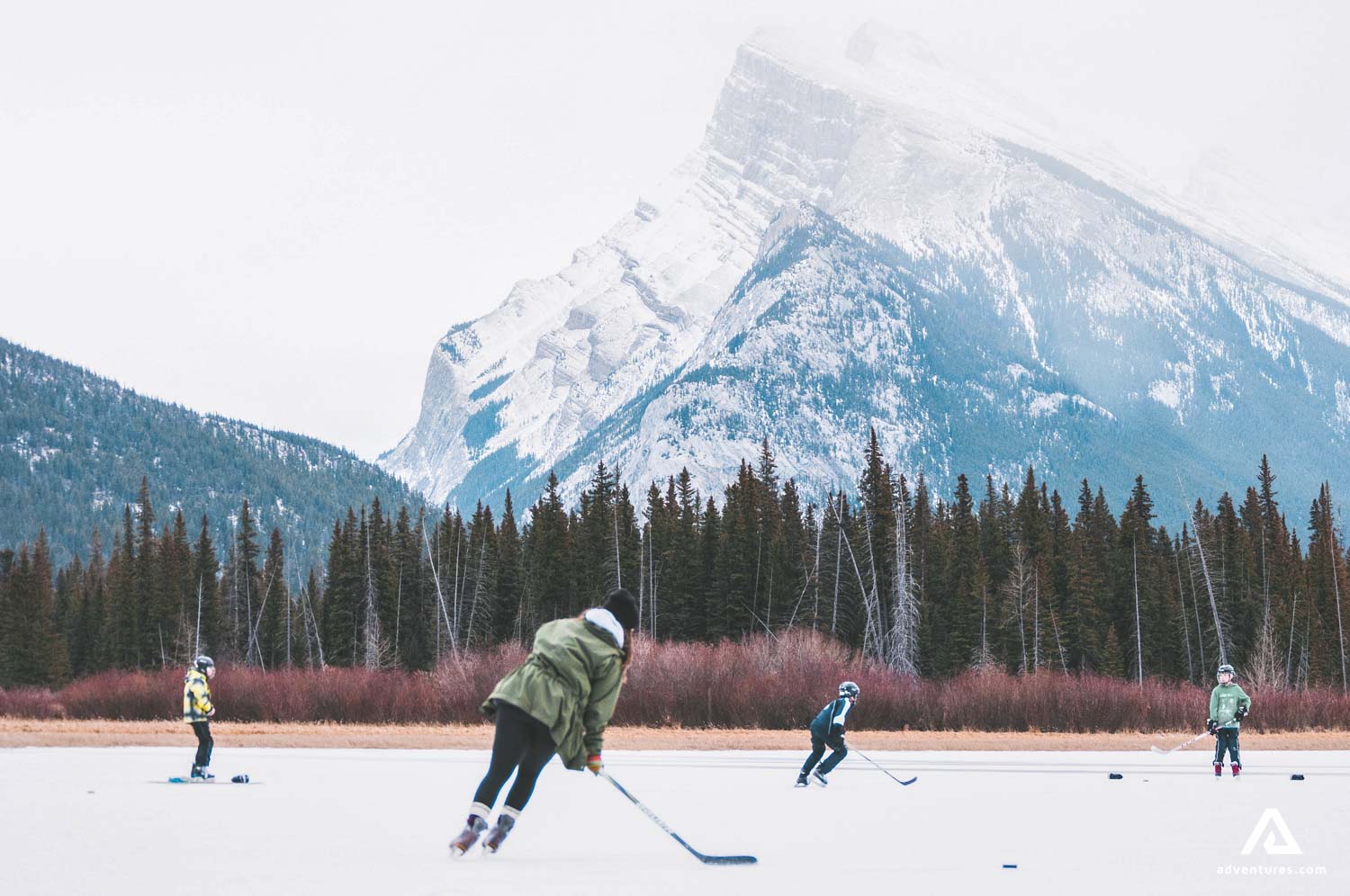 playing hockey on frozen lake in canada