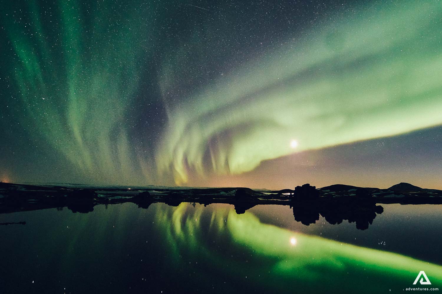 aurora borealis above a lake in iceland
