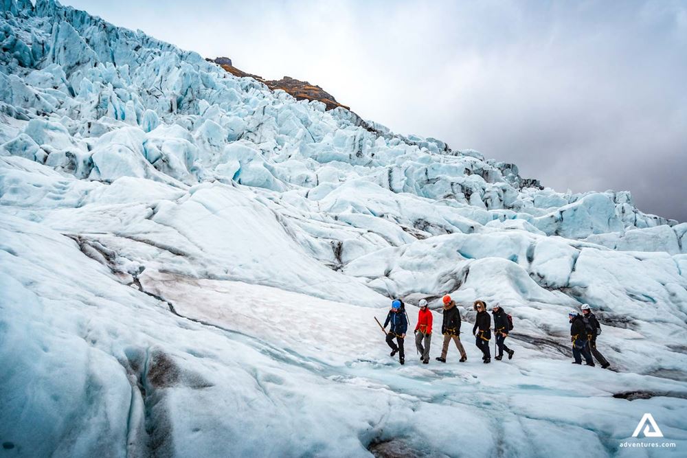 a group hiking a glacier with a guide
