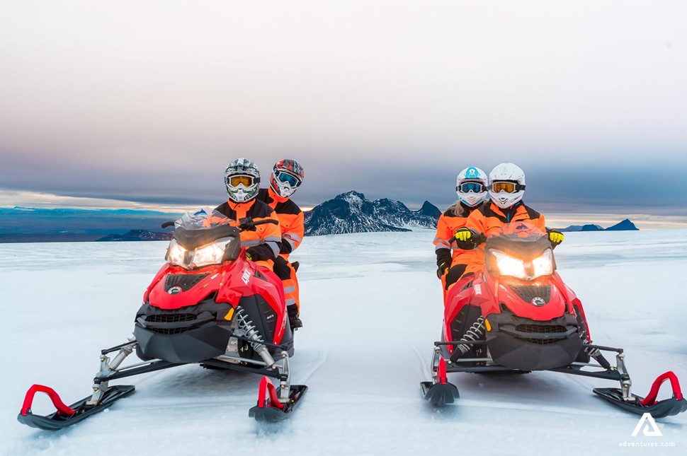 posing for a photo with snowmobiles in iceland