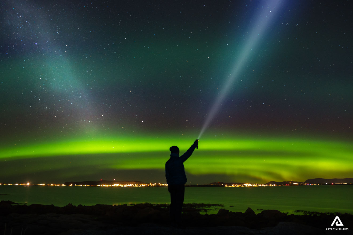 flashing light towards sky and northern lights