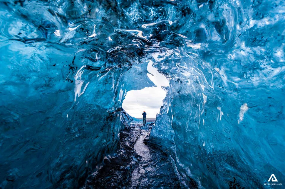 Man Standing In Jokulsarlon Glacier Ice Cave