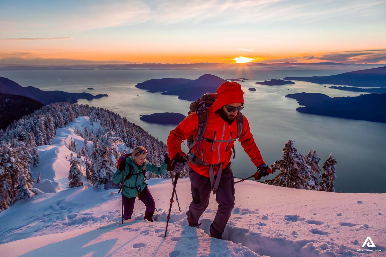 Man and Woman Hiking in the Mountains in winter