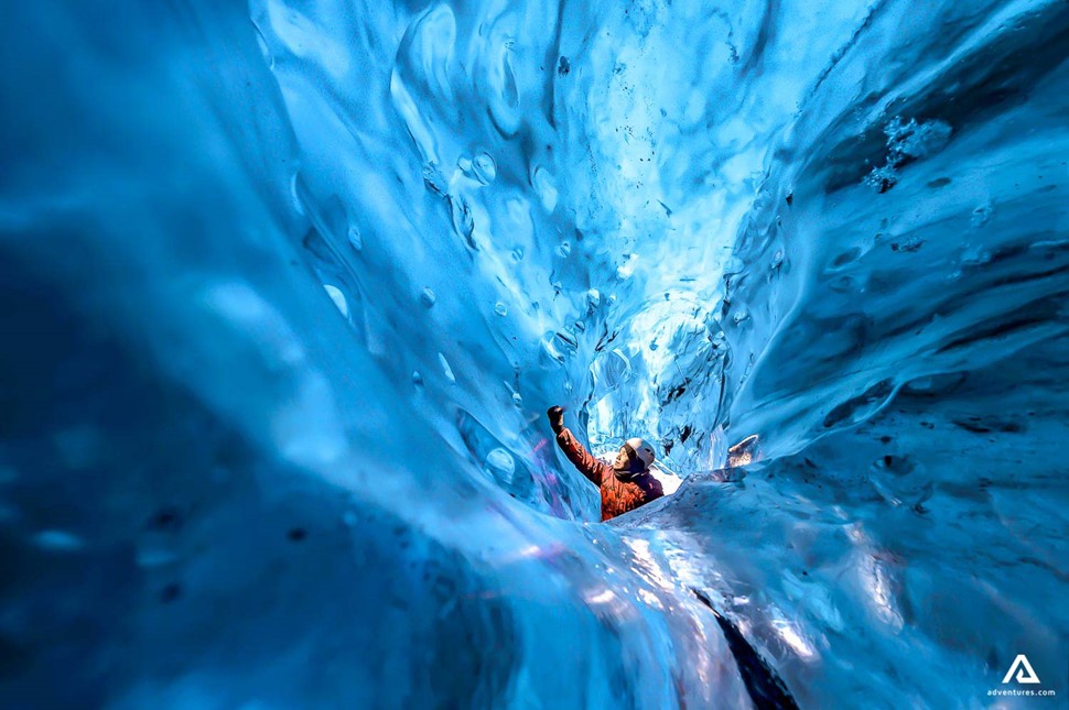 Man Touching Crystal Ice Cave Wall