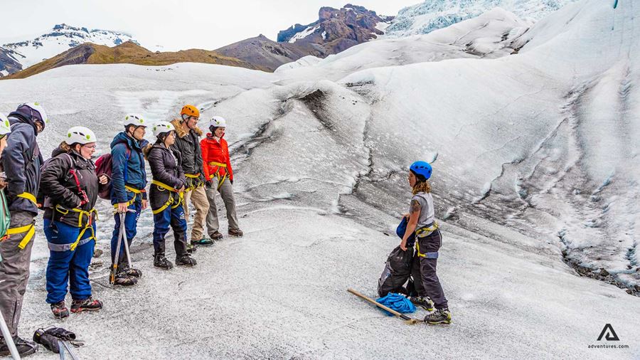 guide on a glacier with a group