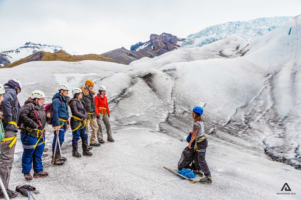 guide on a glacier with a group in iceland