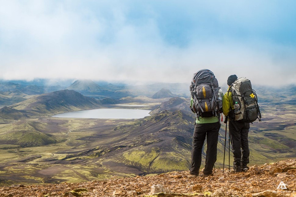 hikers looking from a mountain top in iceland