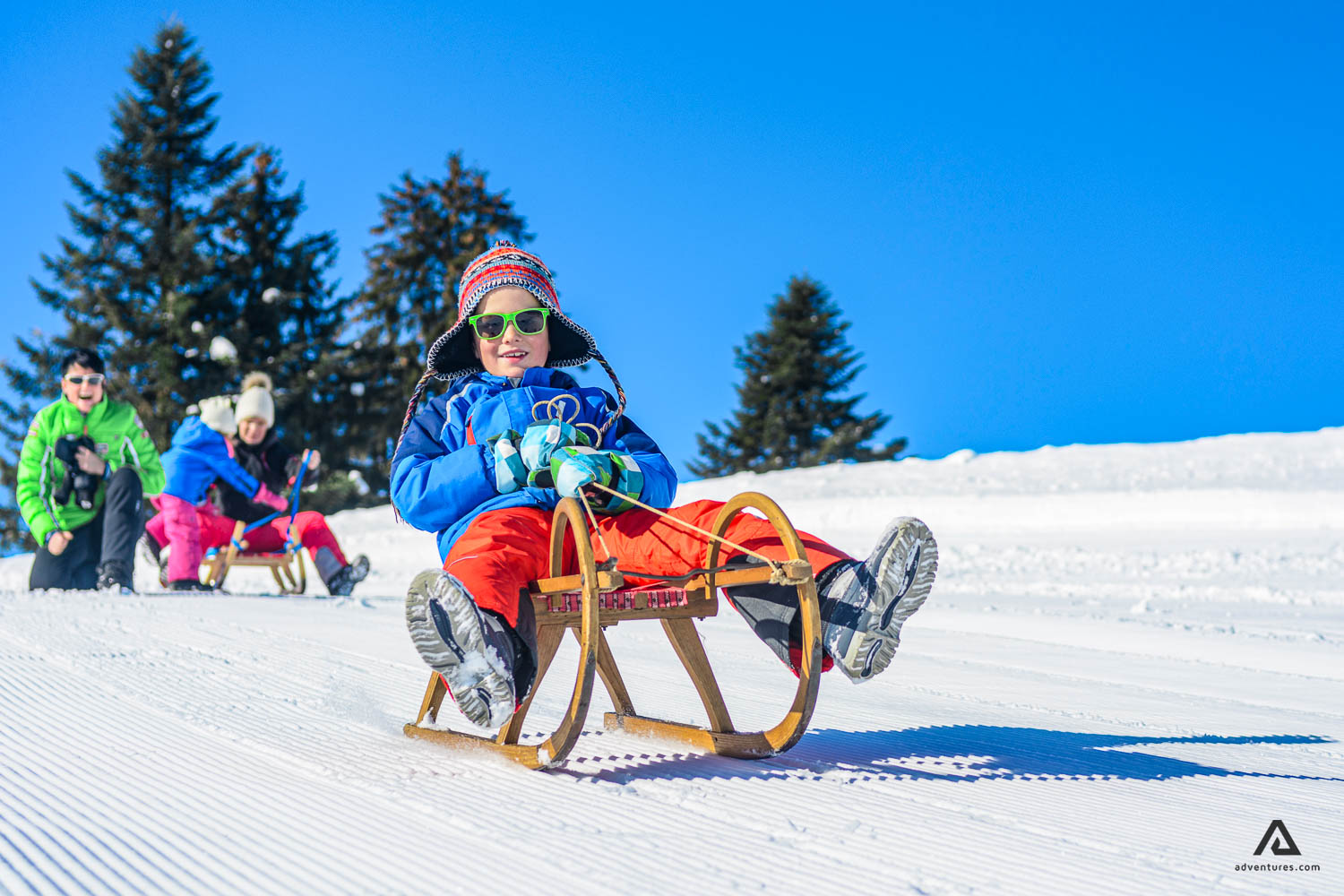 Kid tobogganing in Canada in winter 