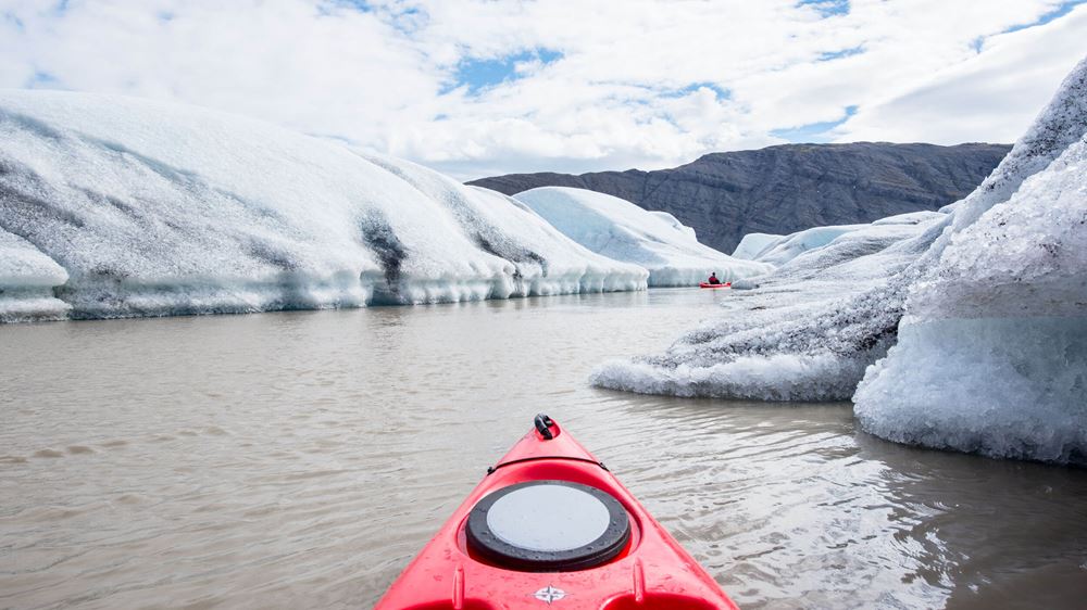 Red kayak on Heinaberslon Glacier