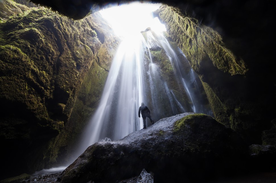 Man inside Gljúfrabúi waterfall