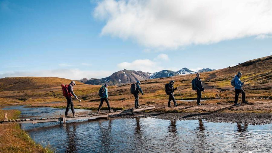 Hikers crossing river in Landmannalaugar