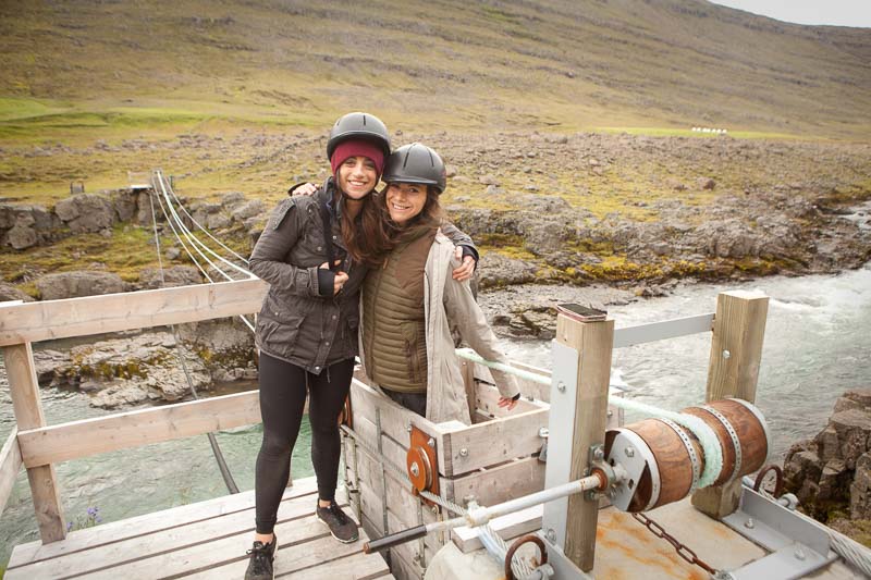 Women smiling near a cable car