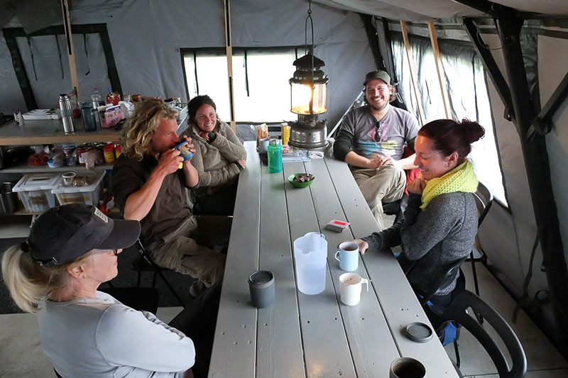People eating lunch in a cabin