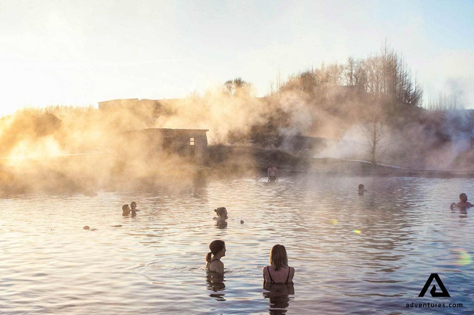 small group bathing in secret lagoon in iceland