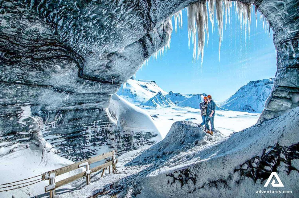 couple posing for a picture at katla ice cave in iceland