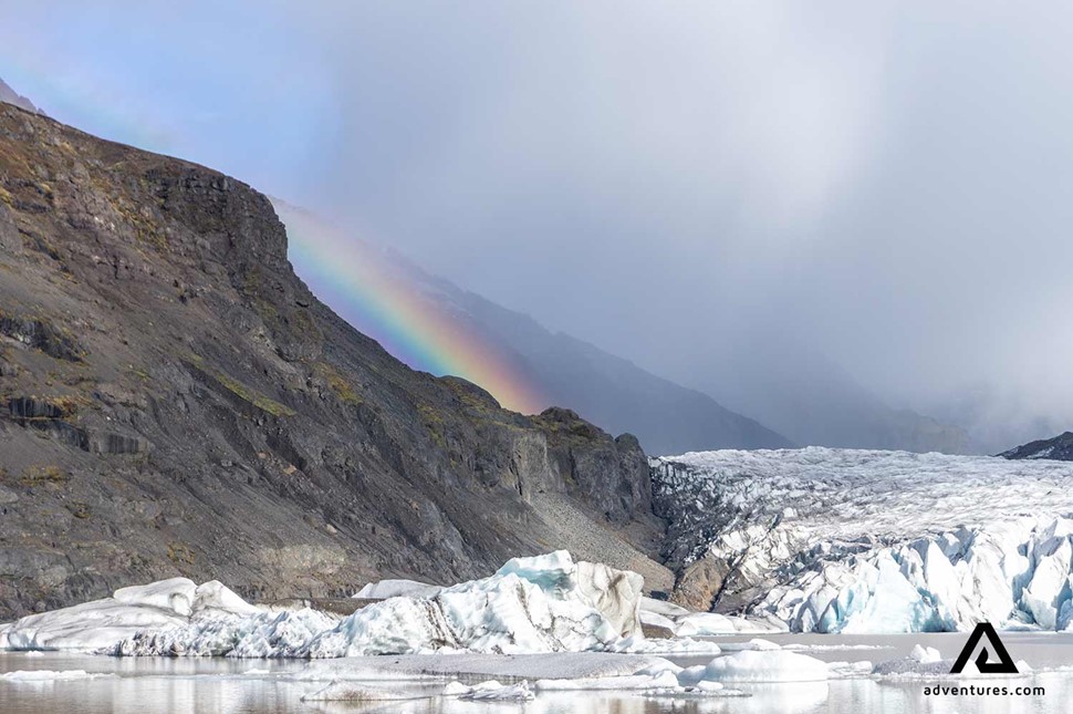 rainbow over svinafellsjokull glacier in iceland