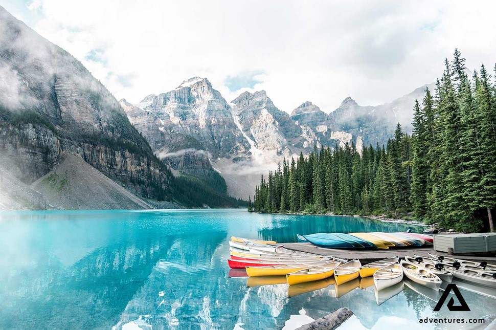 canoes lined up on a lake in banff canada