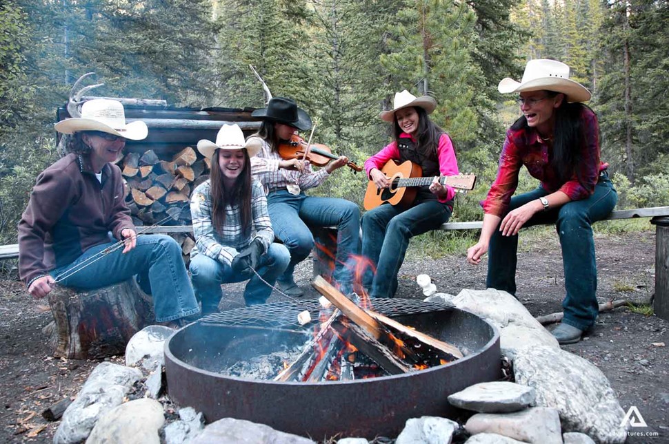 friends singing at a campsite in canada