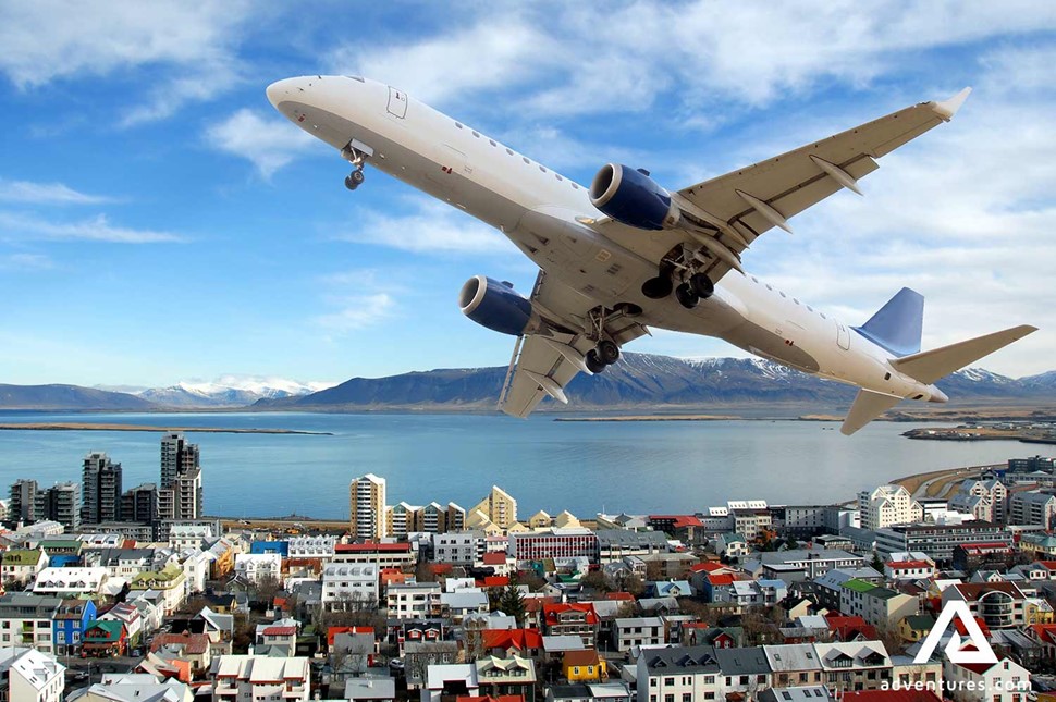 plane flying over city of reykjavik in iceland