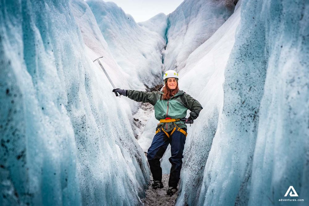 woman with an ice axe in a crevasse