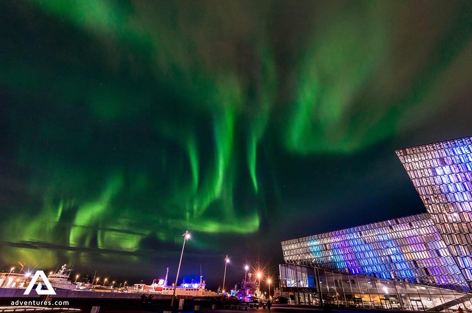 northern lights near concert hall in reykjavik
