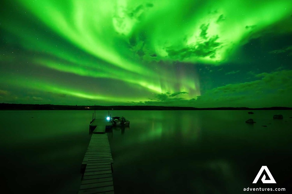 northern lights above a lake in canada at winter
