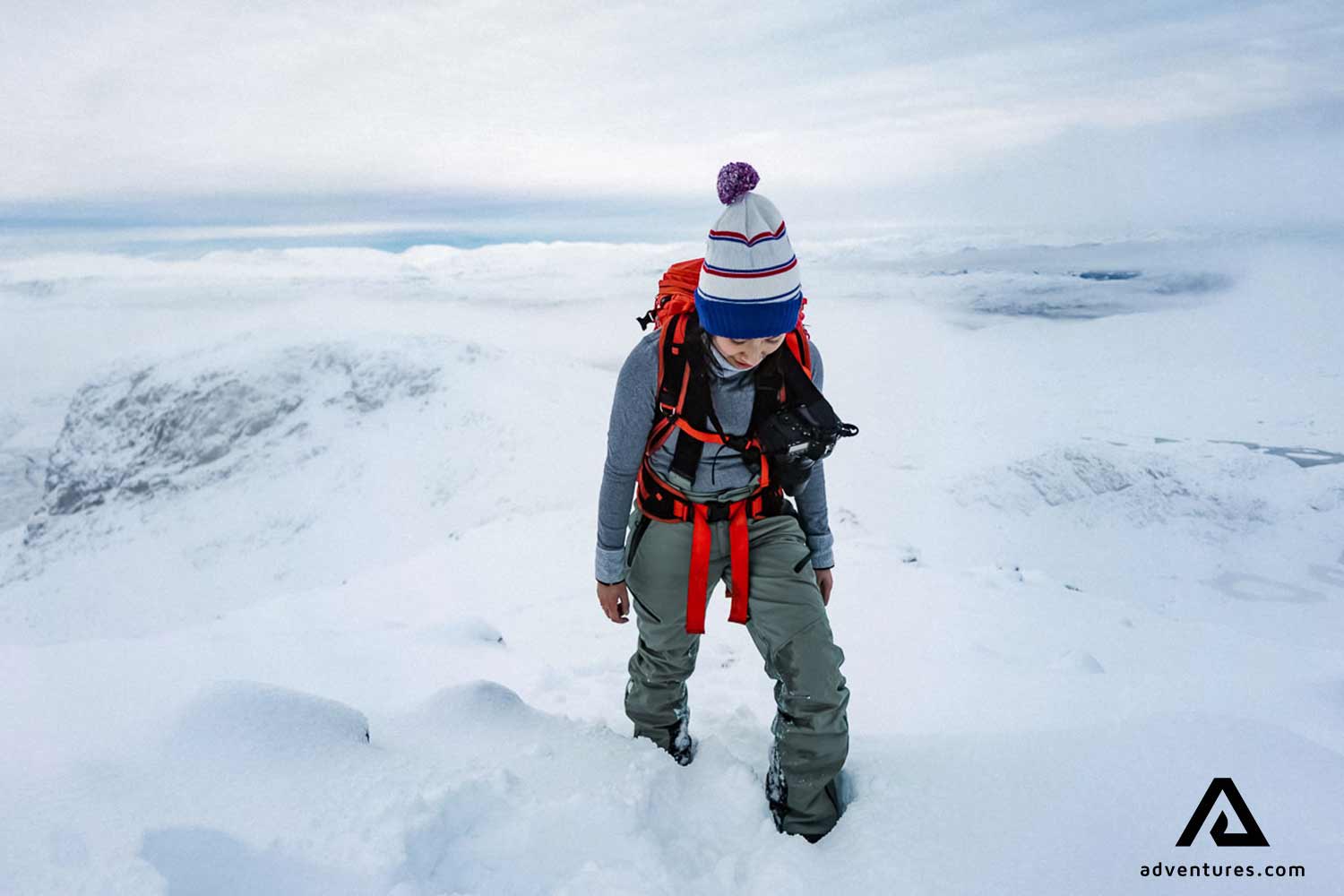 woman walking through snow in iceland