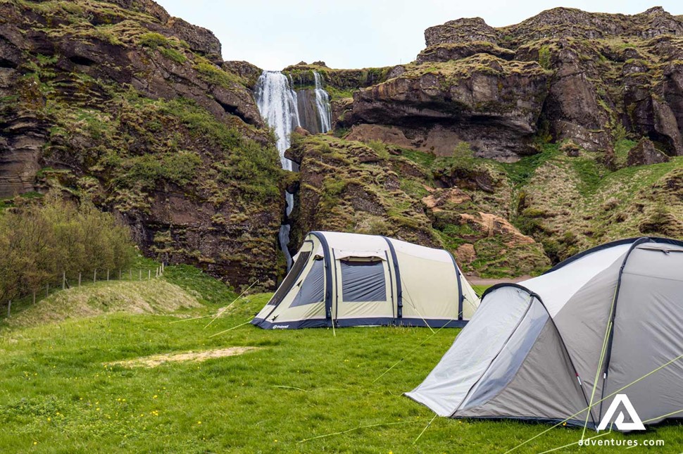 tents near a small waterfall in iceland
