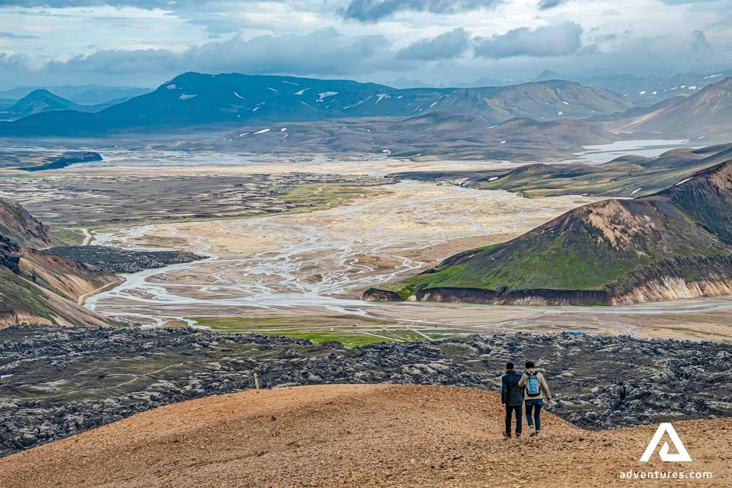 walking down a mountain towards landmannalaugar base camp in iceland