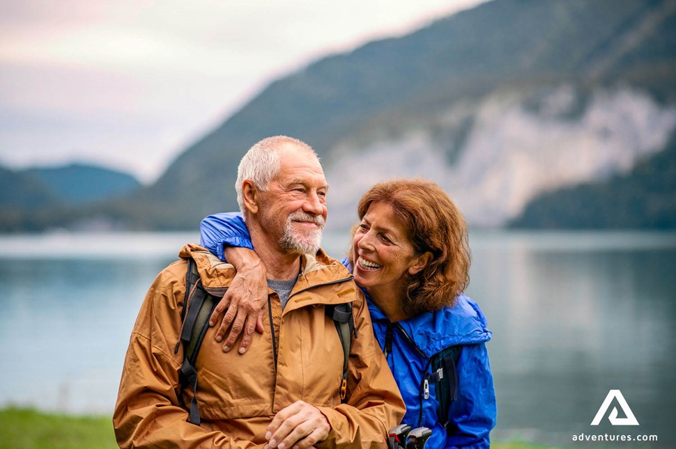 couple smiling and hiking near a lake in iceland