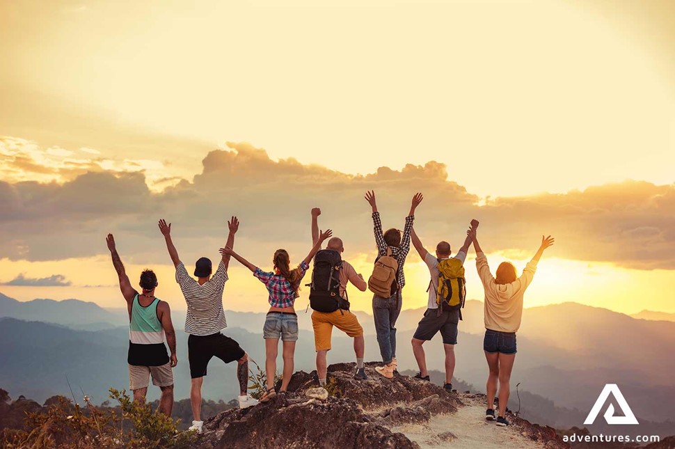 happy group of friends near a sunset