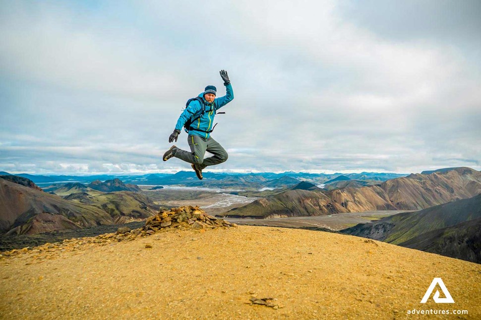 jumping for joy after hiking in iceland